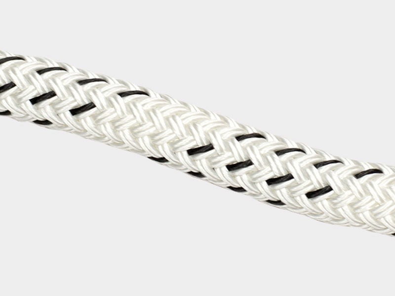 Close-up of a white and black braided synthetic rope for industrial use.