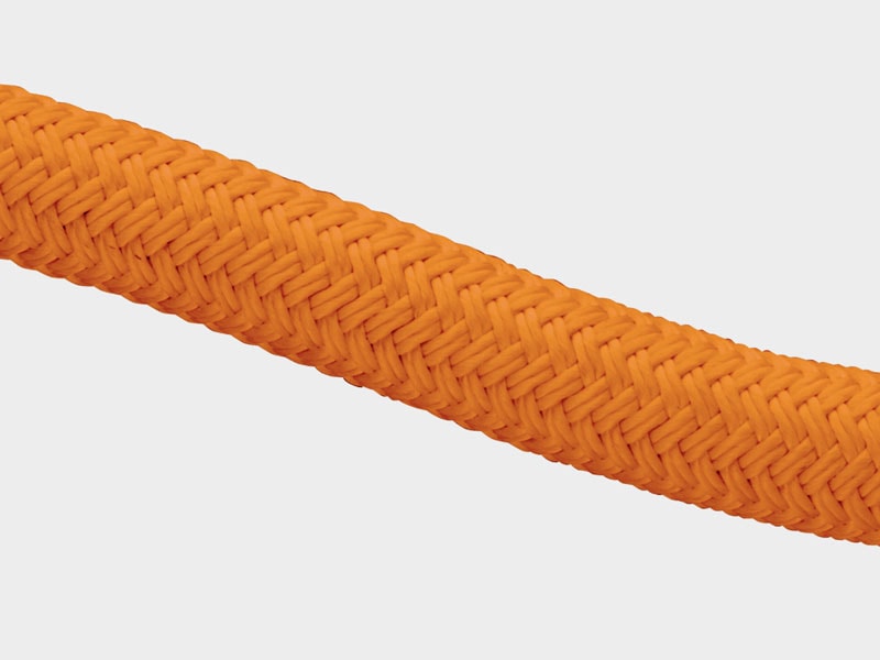 High-strength orange climbing rope with textured surface for safety.