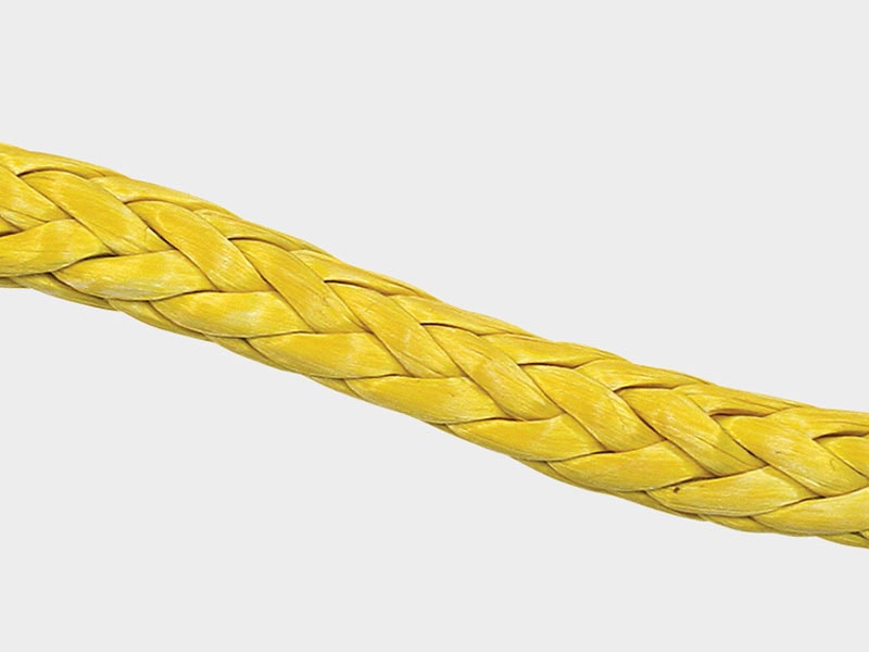 Close-up of a yellow braided fiber rope, durable and strong.