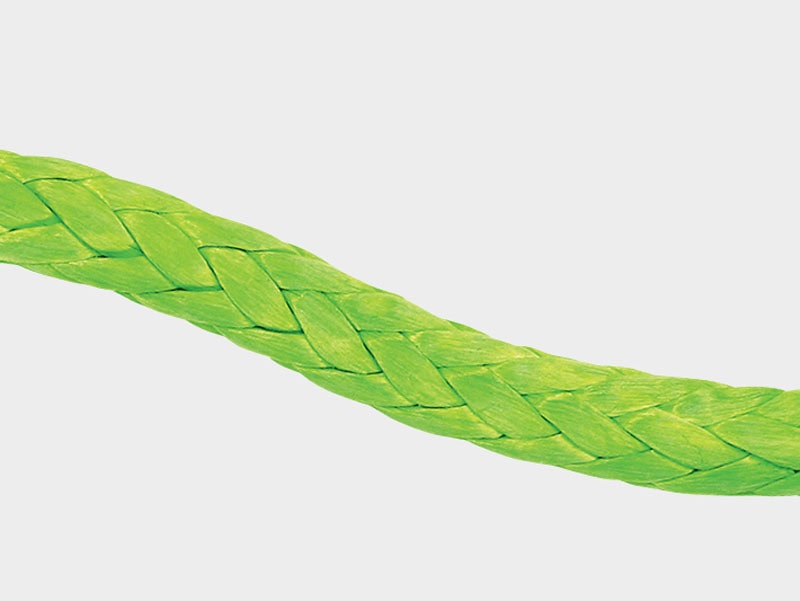 Close-up of a green braided rope, ideal for marine and industrial use.