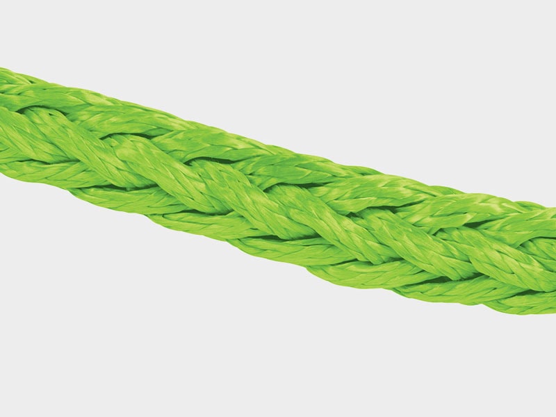 Close-up of a bright green synthetic rope, durable and strong for industrial applications.