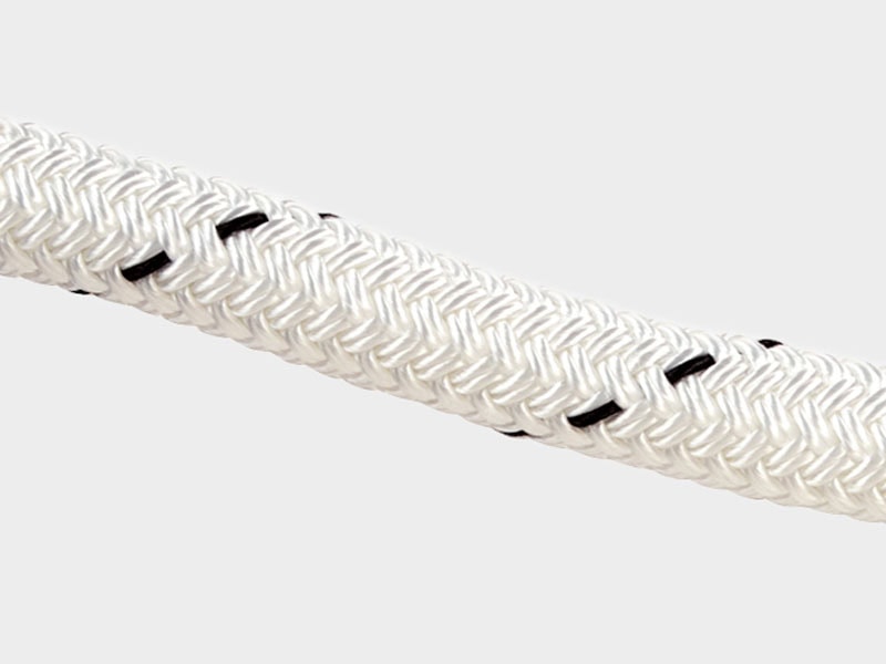 Close-up of white polyester 12 strand rope with black accents for marine applications.