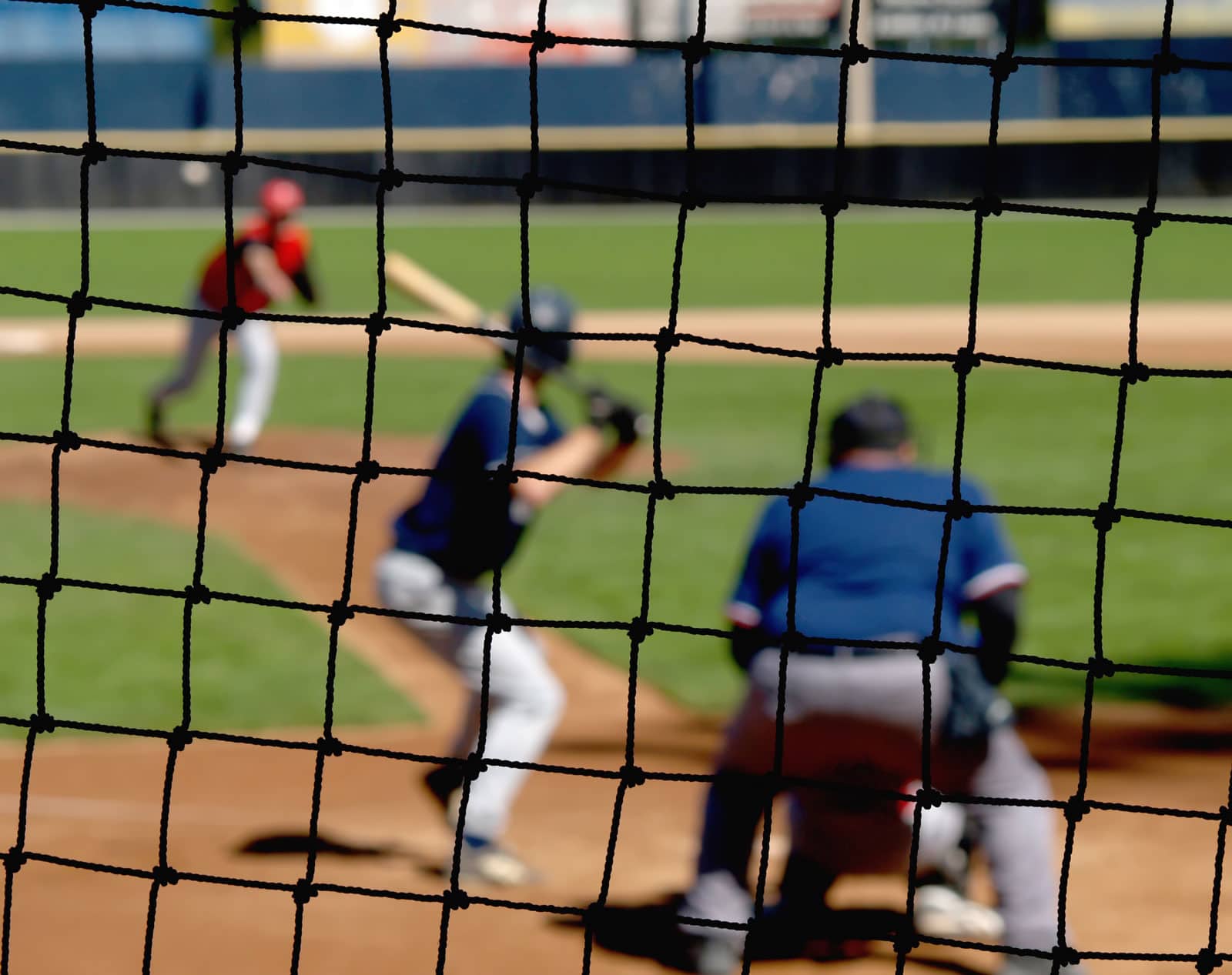 Young baseball players in action during a game on a sunny day.