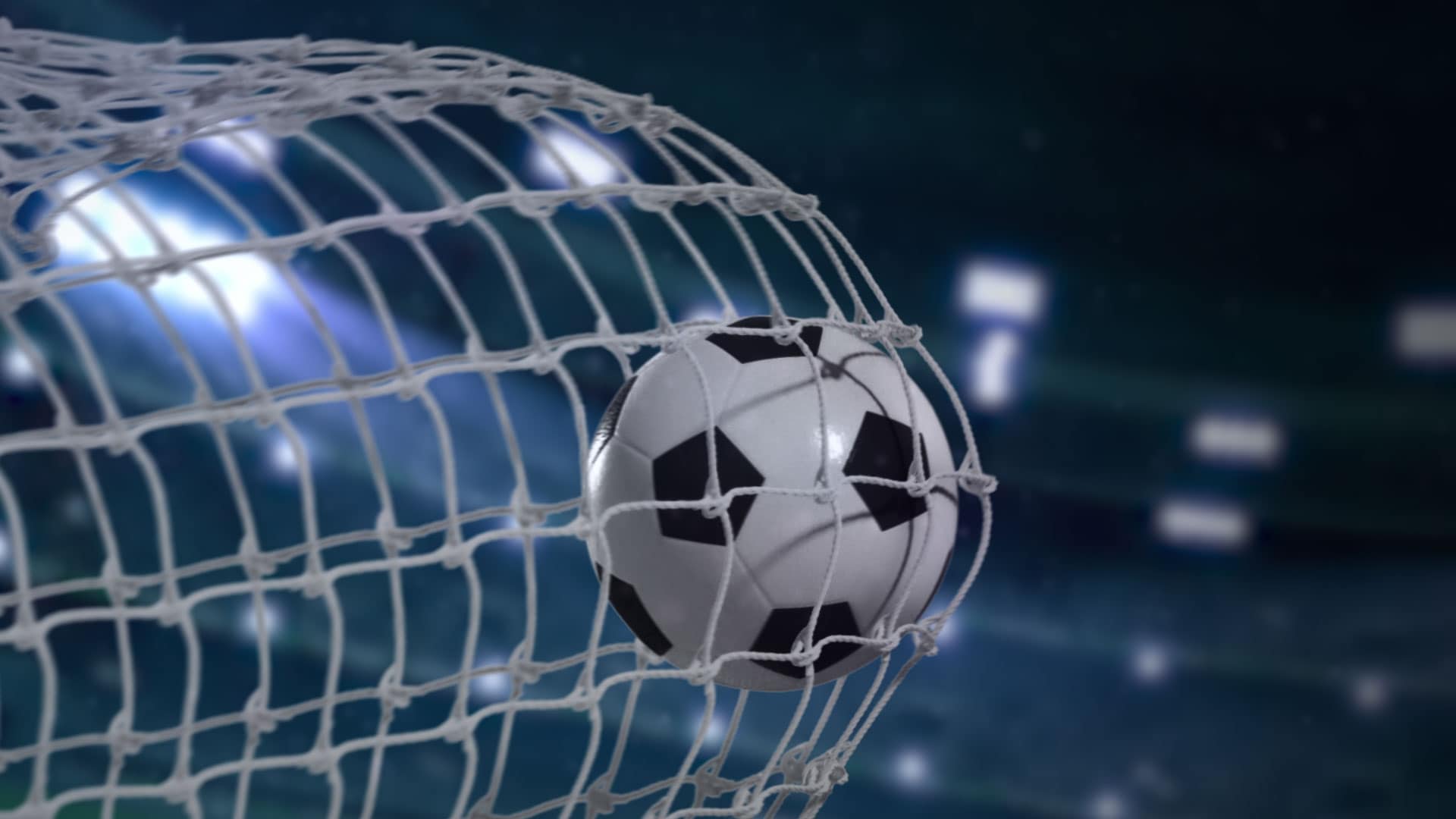 Soccer ball hitting the back of the goal net during a match.