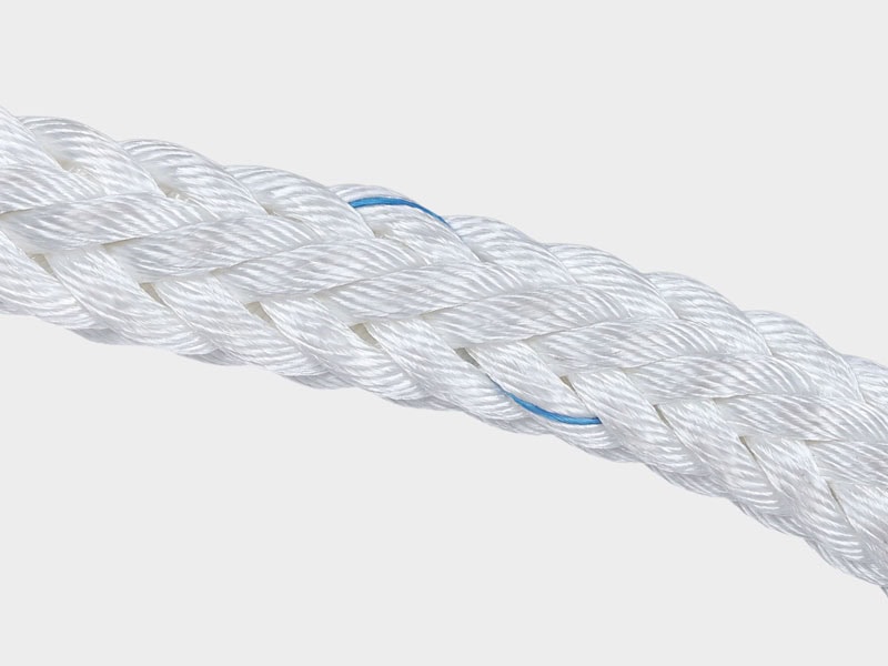 Close-up of white synthetic marine rope with blue accents, durable and strong.